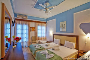 two bed rooms of Vergos Studios in Parga Greece. two beds the balcony and TV